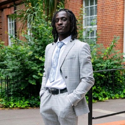 Tobi Alao wearing a grey suit outdoors